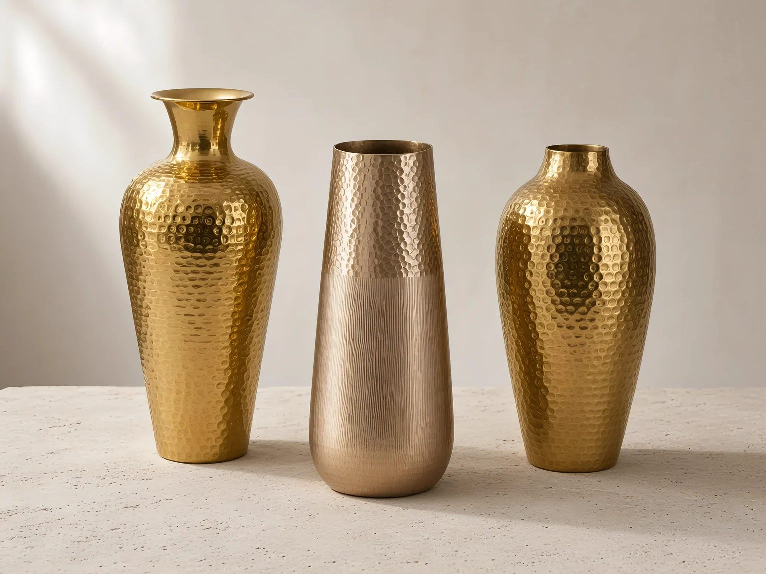 Hammered brass, champagne, and gold metal vases