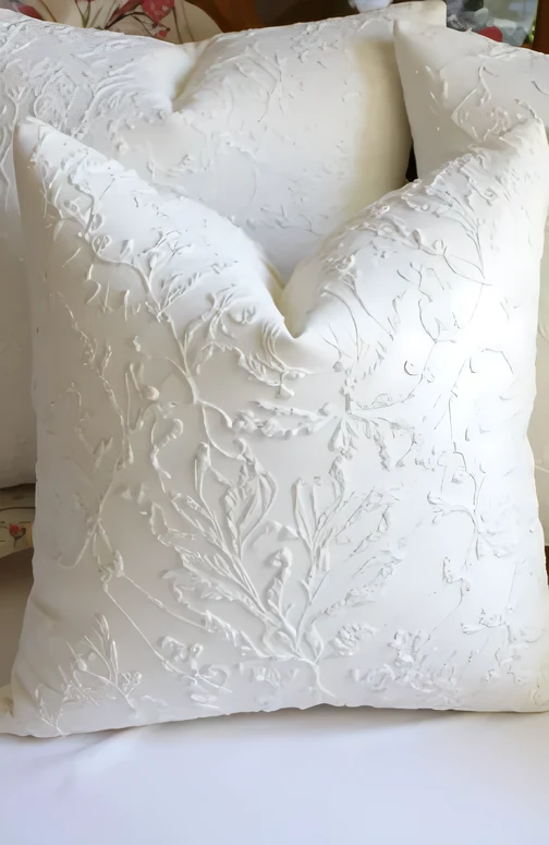 Embroidered cream cushion