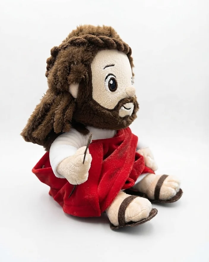 Christ plush toy seen from the side